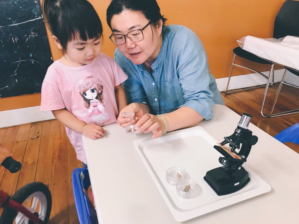Caregiver guiding a child through an early learning activity