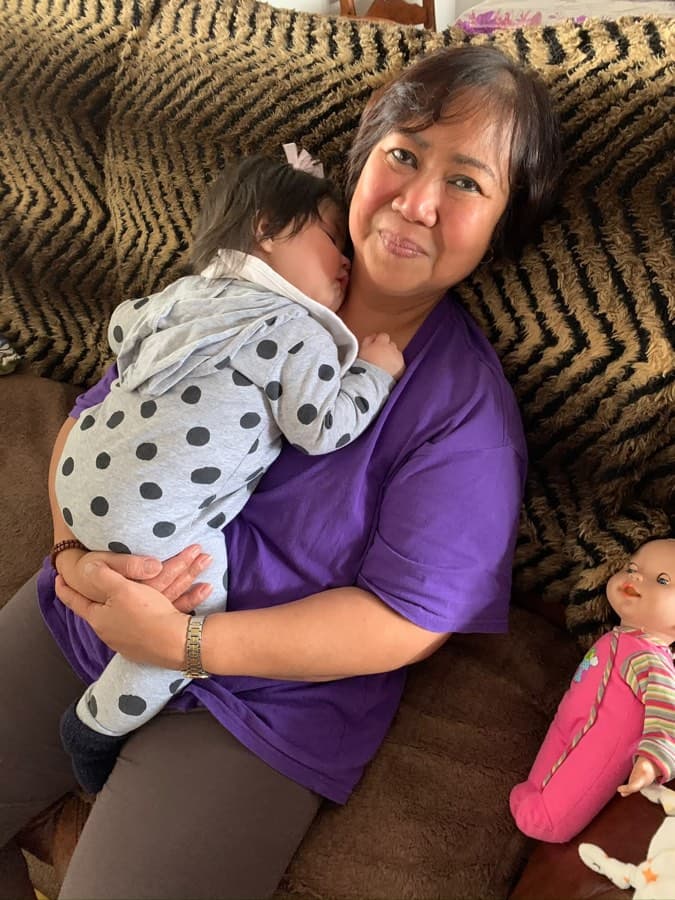 Caregiver holding a sleeping infant