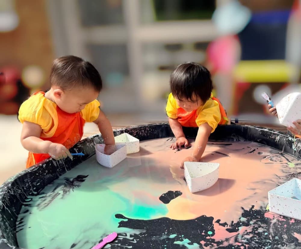 Children exploring a water-play activity together